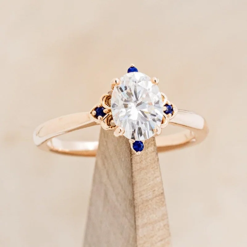 "ZELLA" - OVAL CUT MOISSANITE ENGAGEMENT RING WITH GENUINE BLUE SAPPHIRE ACCENTS